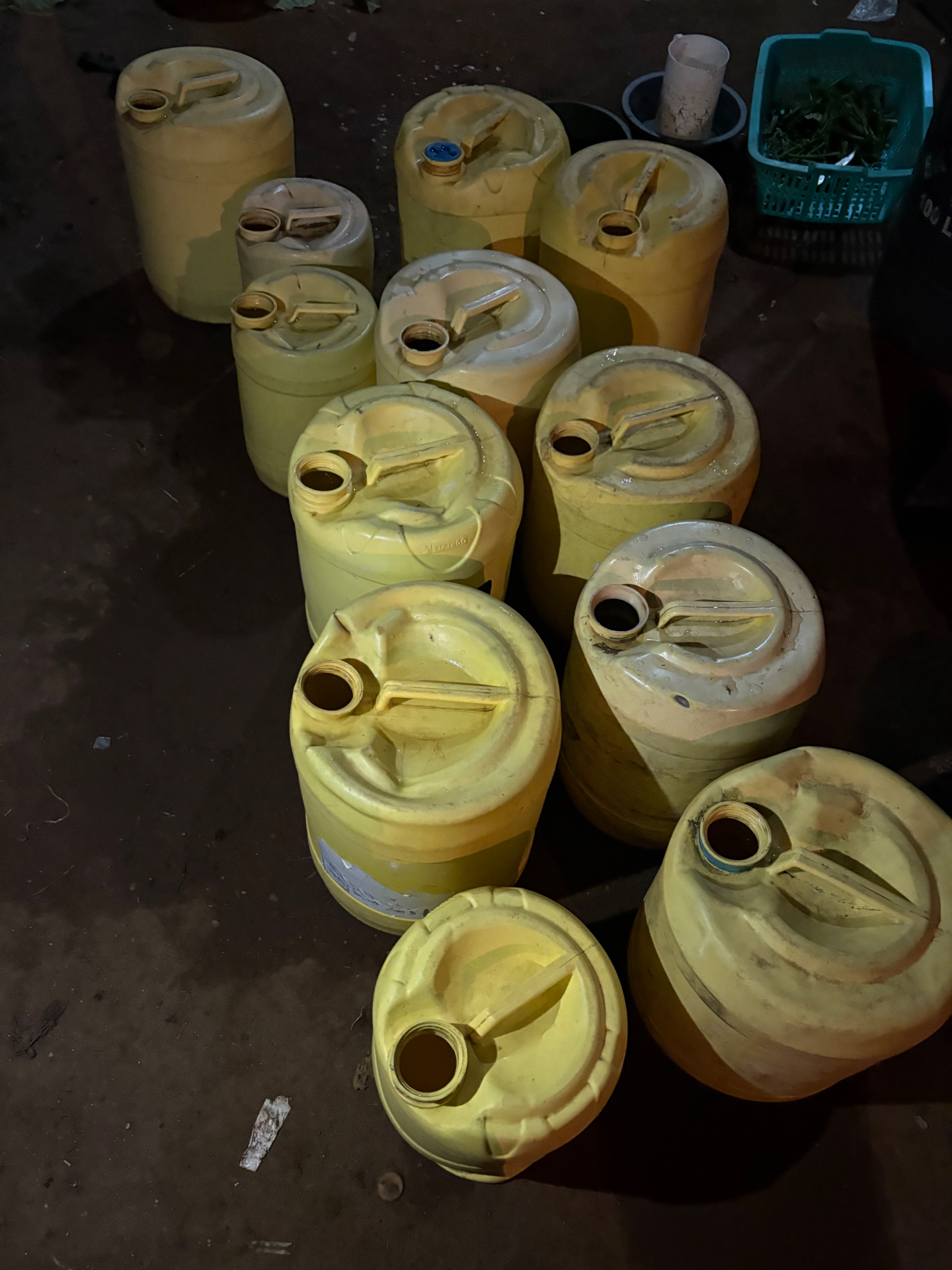 Yellow plastic water containers gathered on the ground in Bondo, Kenya, waiting to be carried to the water station